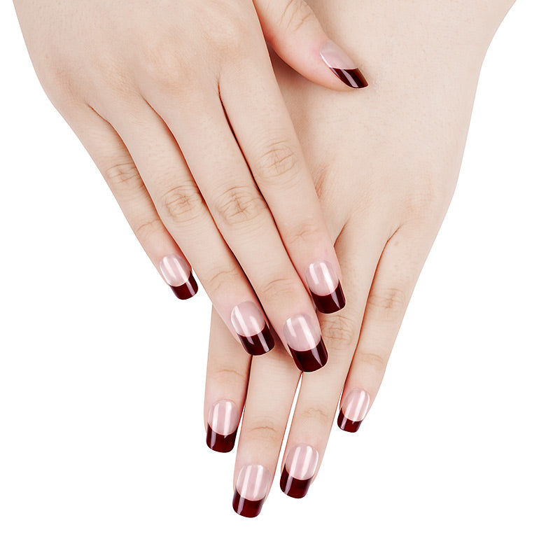 Close-up of hands with burgundy French tip nail wraps applied