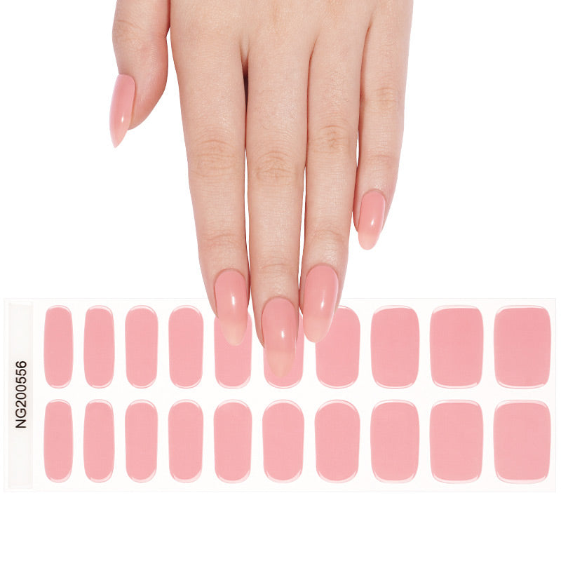 Hand with pink nail polish holding a set of pink nail wraps on a white background