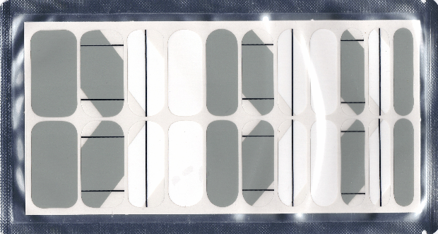 Sheet of geometric gray, white and black adhesive nail polish strips.