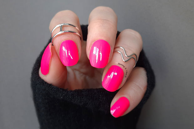 Neon pink nail wraps shown on nails.