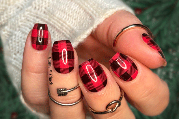 Nails with red and black plaid nail polish strip design.