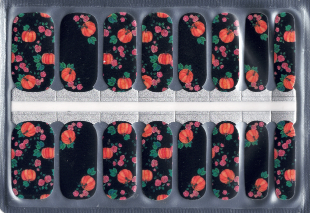 Nail art stickers with pumpkin and leaf designs on a black background in a clear packaging.