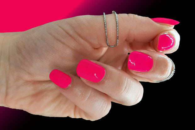 Neon pink nail wraps shown on nails.